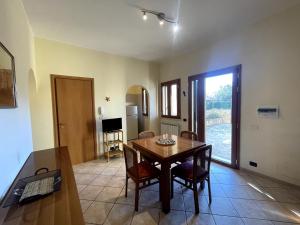 a dining room with a wooden table and chairs at San Cataldo Holiday's in San Cataldo