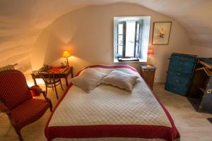 a bedroom with a bed and a chair and a window at Le Jas de Péguier in Châteauneuf-Val-Saint-Donat +86 photos