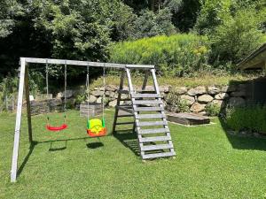 a playground with a ladder and a swing at Ferienhaus Mölltal in Penk
