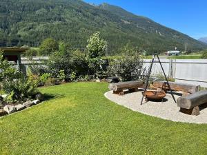 a garden with a swing and a swing at Ferienhaus Mölltal in Penk