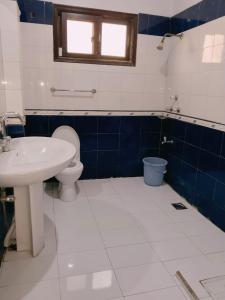 a bathroom with a toilet and a sink at Al Raheem Guest House in Hyderabad