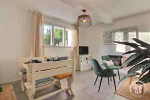 a room with a desk and two chairs and a table at Chez mathieu et gaelle in Binic-Etables-sur-Mer