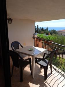 a table and chairs on a balcony with a view of the ocean at Casa vacanze Apollonia in Marina di Camerota