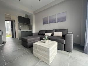 a living room with a couch and a table at Panorama Sunvilles Apartment 3 in Thessaloniki