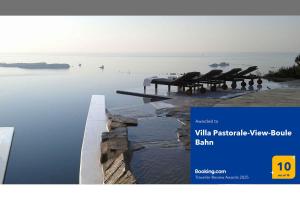 a page of a website with a view of the water at Villa Pastorale-View-Boule Bahn in Agia Irini Paros
