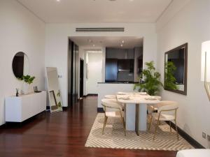 a kitchen and dining room with a table and chairs at Elegant 1BR Full Palm View Apartment at 5 Star Resort in Dubai