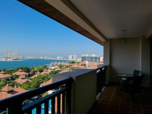 a balcony with a view of the ocean and buildings at Elegant 1BR Full Palm View Apartment at 5 Star Resort in Dubai