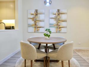 a dining room with a table and two chairs at Ambient 1BR Apartment On The Beach at 5 Star Resort in Dubai
