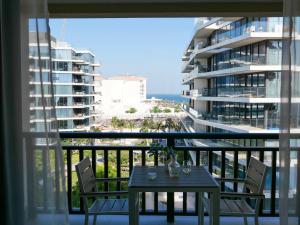 a table and chairs on a balcony with a view of the ocean at Ambient 1BR Apartment On The Beach at 5 Star Resort in Dubai