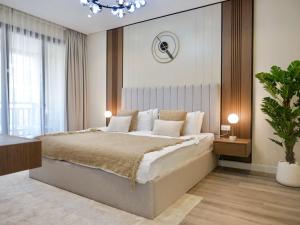 a bedroom with a large bed and a chandelier at Ambient 1BR Apartment On The Beach at 5 Star Resort in Dubai