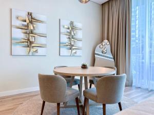 a dining room with a table and chairs at Renovated Marina view apartment in Oceana in Dubai +37 photos