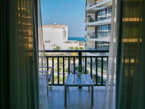 a balcony with a table and a view of the ocean at Ambient 1BR Apartment On The Beach at 5 Star Resort in Dubai