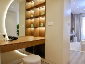 a home office with a desk and a room at Ambient 1BR Apartment On The Beach at 5 Star Resort in Dubai