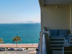 a view of the ocean from a hotel balcony at Ambient 1BR Apartment On The Beach at 5 Star Resort in Dubai