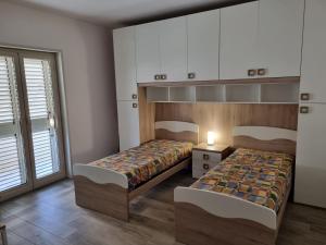 Ένα ή περισσότερα κρεβάτια σε δωμάτιο στο Apartment Milazzo - Trilocale sul mare