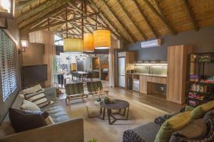 a living room with a couch and a table at Kubu Metsi Lodge in Matlhagame