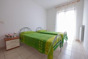 Ένα ή περισσότερα κρεβάτια σε δωμάτιο στο Ficus 3 - Pineto Vacanza