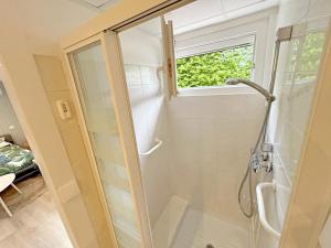 a bathroom with a shower with a glass door at Gite Grand Chantilly -Maison 2CHB-2SDB 6p & Studio 2p in Châteauroux