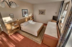 Postel nebo postele na pokoji v ubytování Hotel Waldheim Belvedere