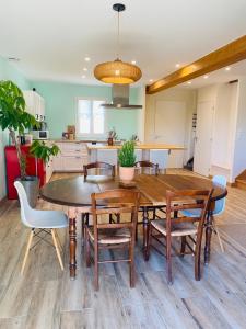 a kitchen and dining room with a wooden table and chairs at Chez Georges - Maison 3 - les Gîtes du Verdon in Esparron-de-Verdon +38 photos