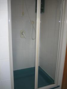 a shower with a glass door in a bathroom at Haus Osterried in Schwangau +22 photos