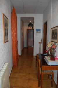 a hallway with a table and a dining room at Casa Cleo in Rome