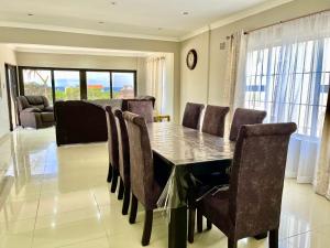 a dining room with a table and chairs at Regent House in Durban