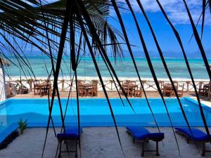 a view of the beach from a resort swimming pool at Mia Boutique Hotel & Restaurant in Michamvi
