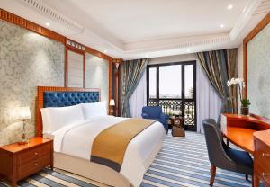 a hotel room with a bed and a desk and a desk at The Ritz-Carlton Jeddah in Jeddah +93 photos