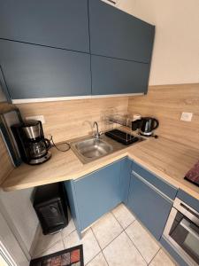 a kitchen with a sink and a counter top at La maison de la mer in Fleury
