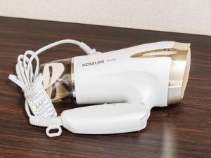 a white hair dryer sitting on a wooden table at Shinjuku/Shin-Okubo Sta 2min walk/Kabukicho 5 min in Tokyo