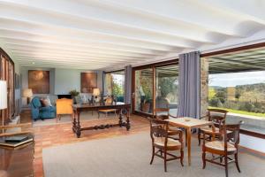 a living room with a table and chairs at Exquisite farmhouse in the Empordà Costa Brava in Vall-Llobrega