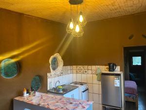 a kitchen with a sink and a stove top oven at Eco Tiny House in Panguipulli