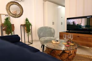 a living room with a couch and a table and a tv at La Vie Douce - T3 chic à Bonifacio classé 4 étoiles in Bonifacio +26 photos