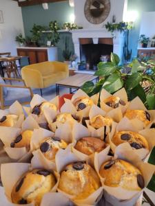 a pile of muffins sitting on top of a table at L Amalia au cœur des Châteaux de la Loire et du zoo de Beauval in Sambin