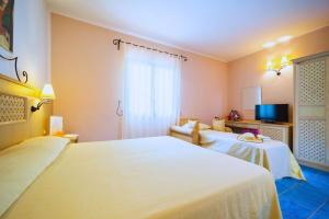 Postel nebo postele na pokoji v ubytování Hotel Ipomea Club