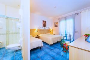 Postel nebo postele na pokoji v ubytování Hotel Ipomea Club