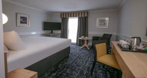 a hotel room with a large bed and a desk at Best Western Appleby Park Hotel in Tamworth