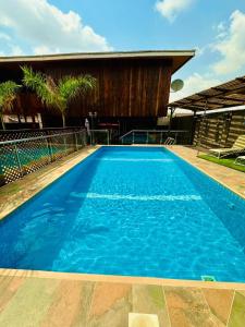 a large blue swimming pool in front of a building at Golden Crystal Hotel in Accra