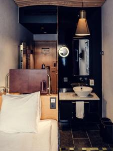 a bedroom with a sink and a bed and a mirror at U&Me; BW Signature Collection in Umeå +77 photos