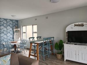 a living room with a couch and a table at Ocean Breaks in Umdloti