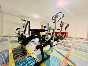 a gym with treadmills and ellipticals in a room at GuestHouse University by LR - self check in in Lugano