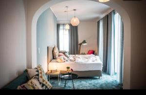 a bedroom with a bed and a couch and a table at Strandhaus am Wörthersee in Velden am Wörthersee