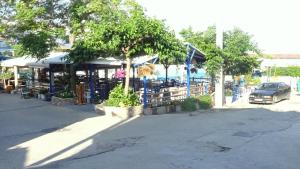 a car is parked in front of a market at RelaxRooms #1 in Skala Marion