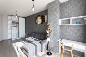 a living room with a couch and a table at Cozy place New Boulevard in Batumi