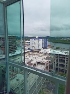 a view of a city from an office window at Kitnet da Maria in Guarapari