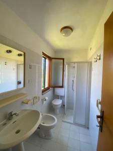 a bathroom with a sink and a toilet and a shower at Casale Conci in Casa Ajali
