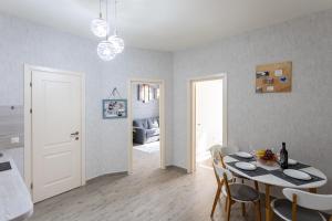 a kitchen and dining room with a table and chairs at Cozy place New Boulevard in Batumi