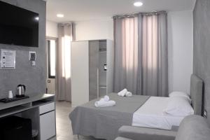 a hotel room with a bed with towels on it at Le Meraviglie in Sanremo