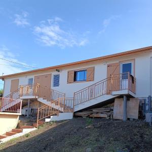 a house with stairs on the side of it at Maison de vacances à Deshaies 971 in Deshaies